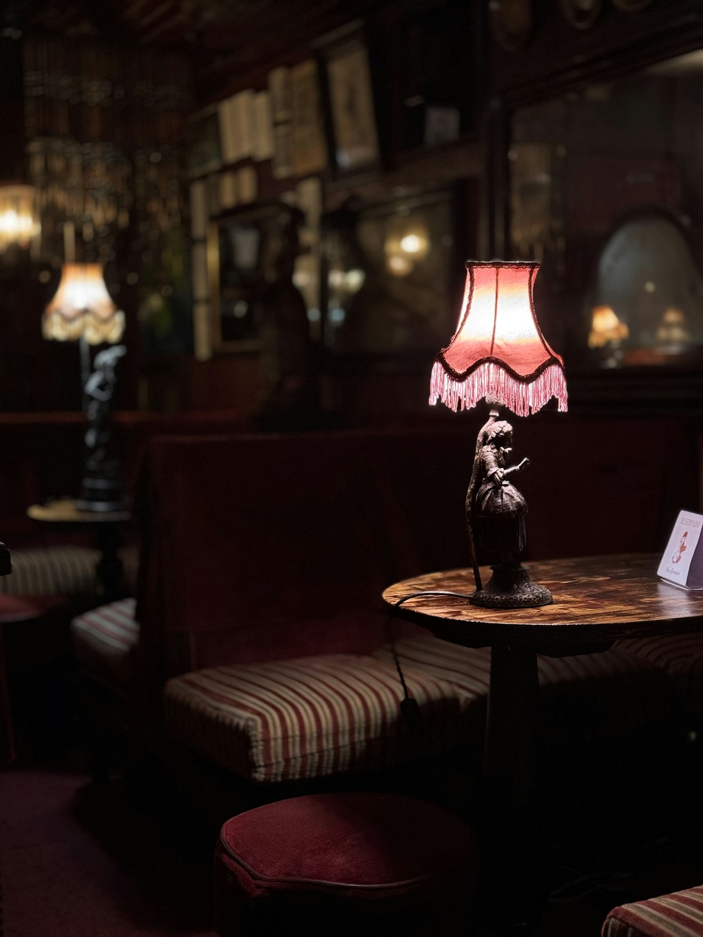 A lamp-lit booth in a dim bar