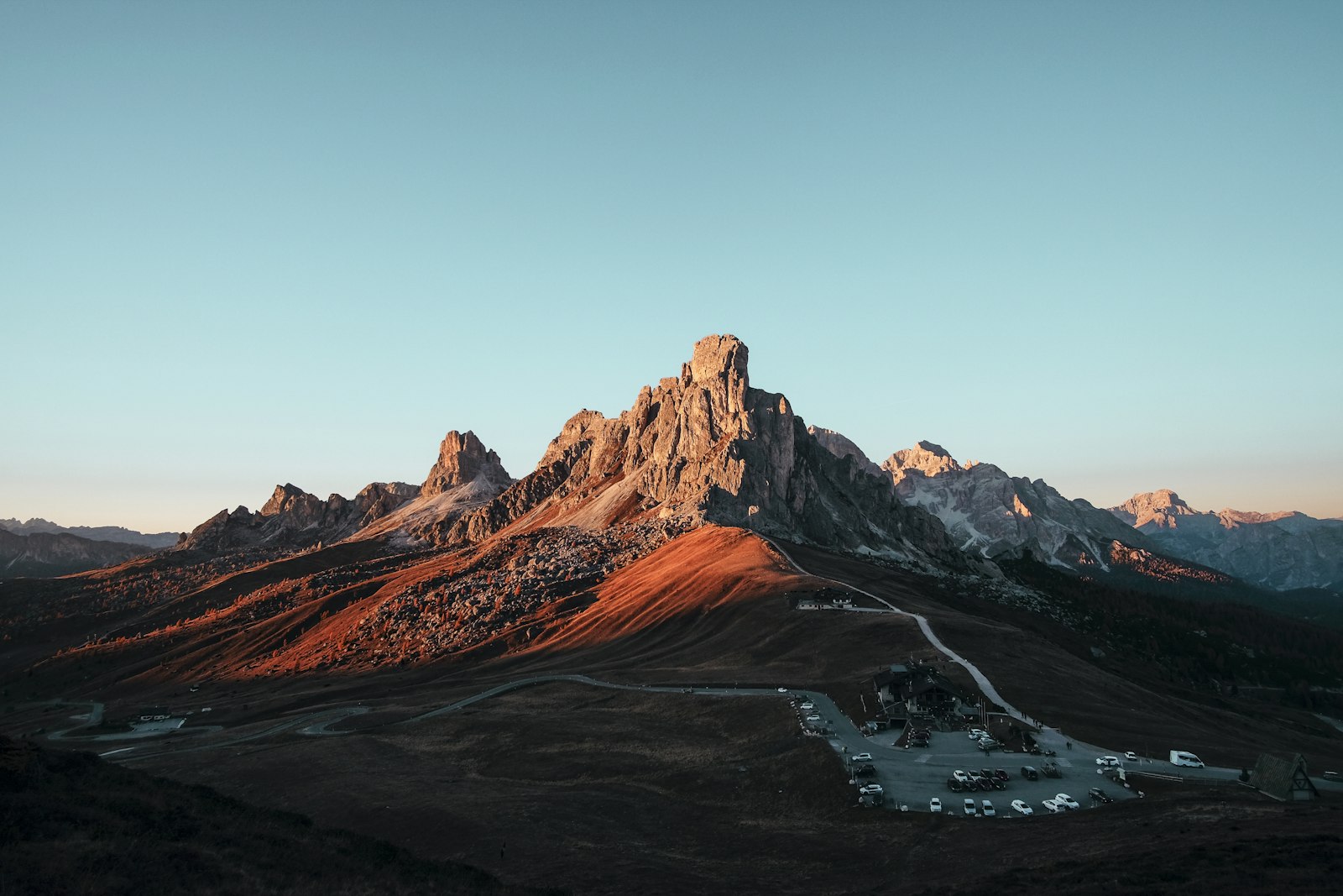 A sharp peak lit red at first light
