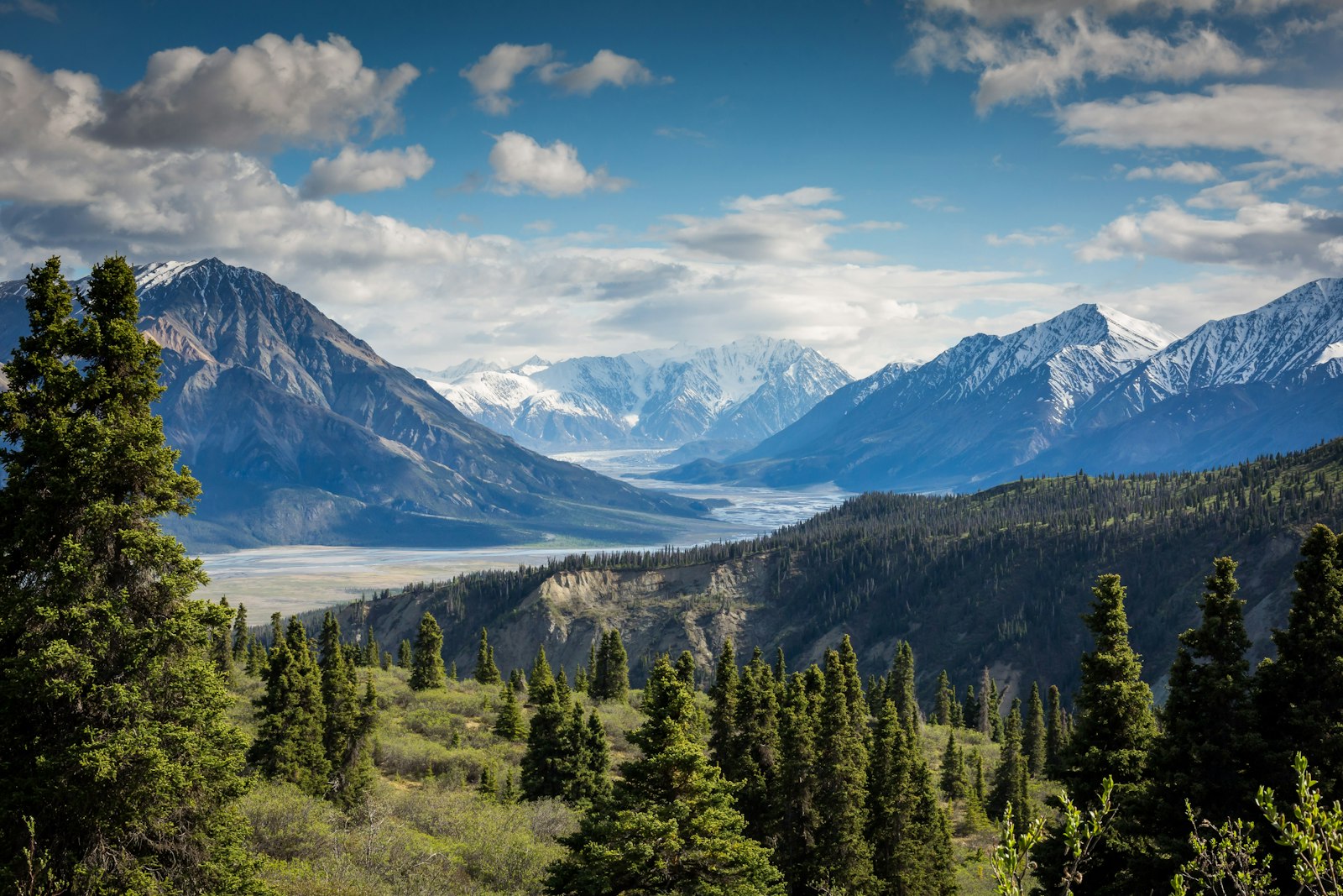 A wide valley beneath snow peaks